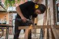 Ein junger Mann bearbeitet mit einer Maschine Metall. | Foto: Hendrik Silbermann (ARTWORks)